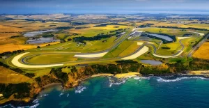 An arial view above the ocean looking over the Phillip Island race track and coastal cliffs