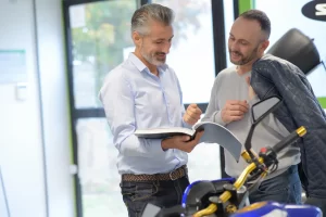 A manu discusses purchase of a used motorcycle from a dealership